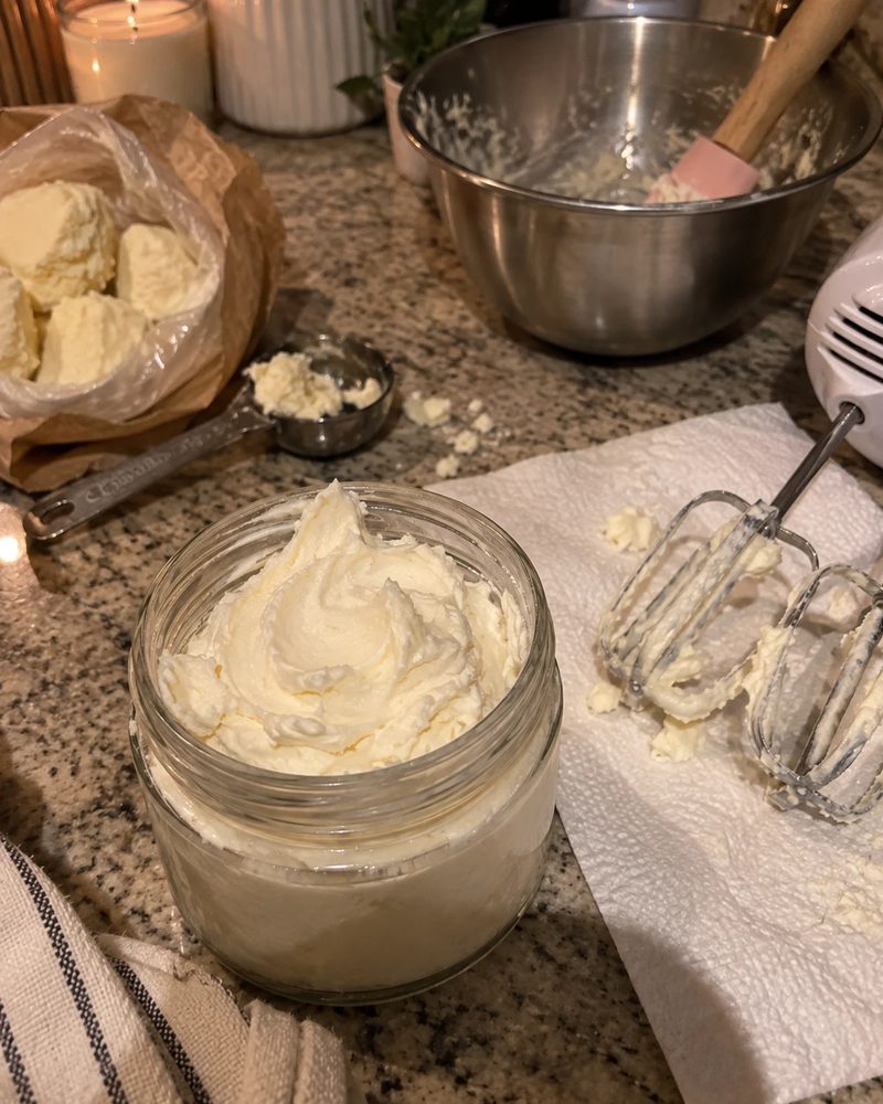 A freshly whipped jar of body butter on a kitchen counter